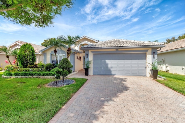 single story home featuring a garage, a front yard, decorative driveway, and stucco siding