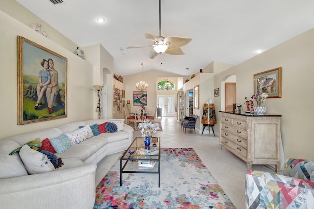 living area with light tile patterned floors, arched walkways, recessed lighting, ceiling fan with notable chandelier, and vaulted ceiling