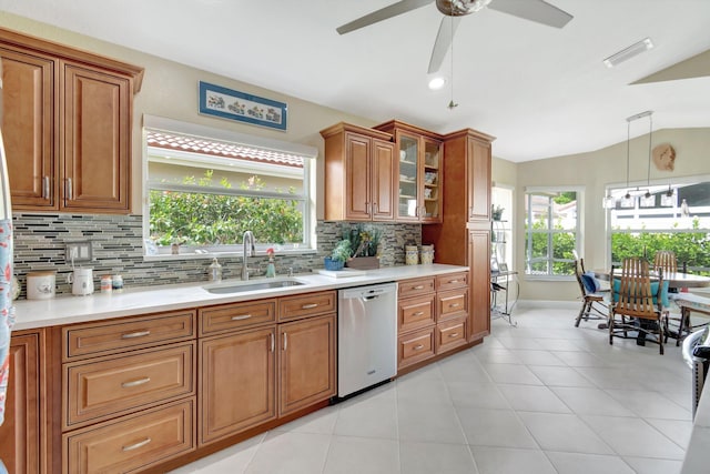 kitchen with light countertops, visible vents, brown cabinetry, a sink, and dishwasher