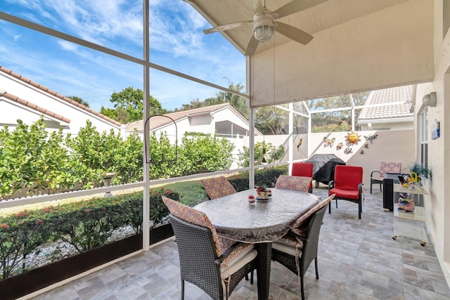 sunroom featuring ceiling fan