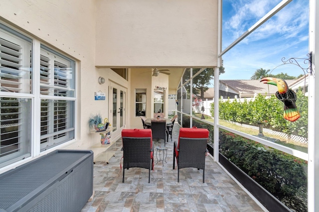 sunroom featuring a ceiling fan