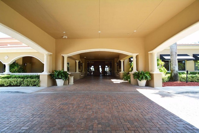 doorway to property featuring stucco siding