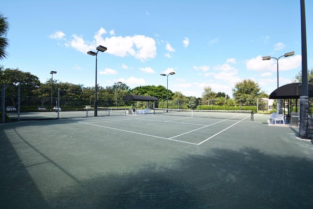 view of sport court featuring fence