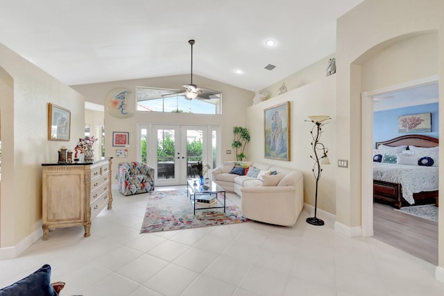 living room featuring baseboards, visible vents, arched walkways, lofted ceiling, and french doors