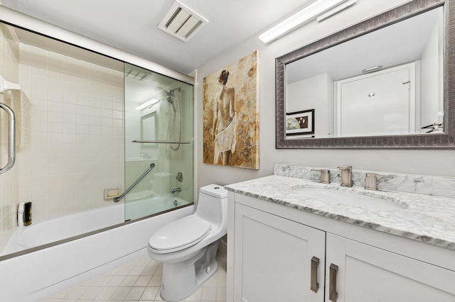 bathroom featuring tile patterned flooring, toilet, bath / shower combo with glass door, vanity, and visible vents