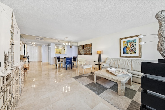 living room featuring visible vents and a textured ceiling