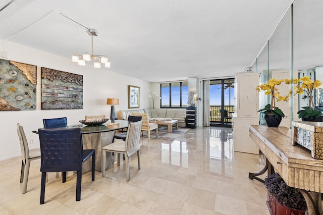 dining area featuring expansive windows, a chandelier, and a textured ceiling