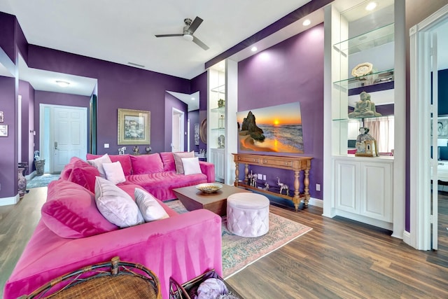 living area featuring ceiling fan, visible vents, baseboards, and wood finished floors