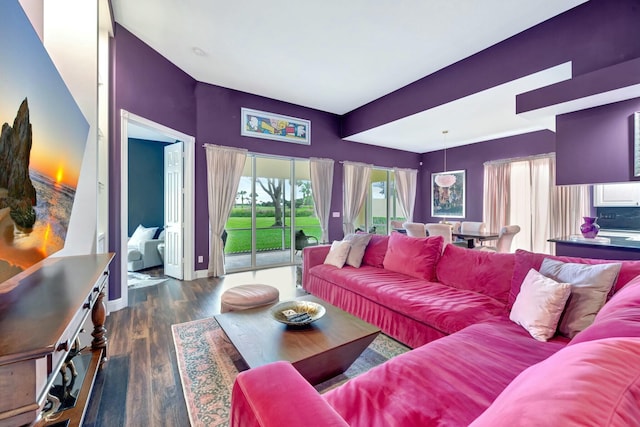 living area featuring baseboards and wood finished floors