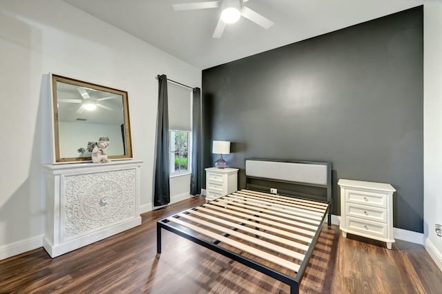 bedroom with ceiling fan, baseboards, and wood finished floors