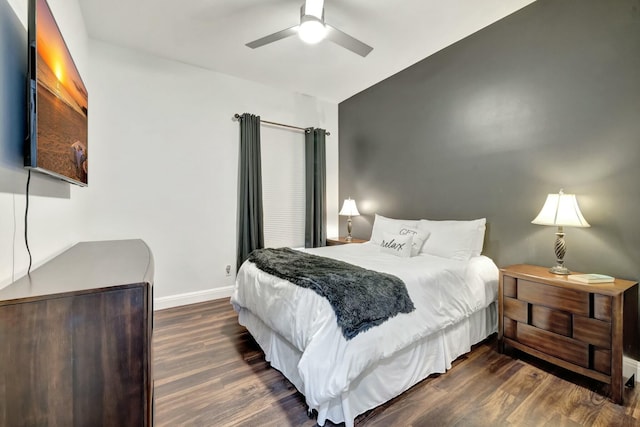 bedroom with ceiling fan, baseboards, and wood finished floors