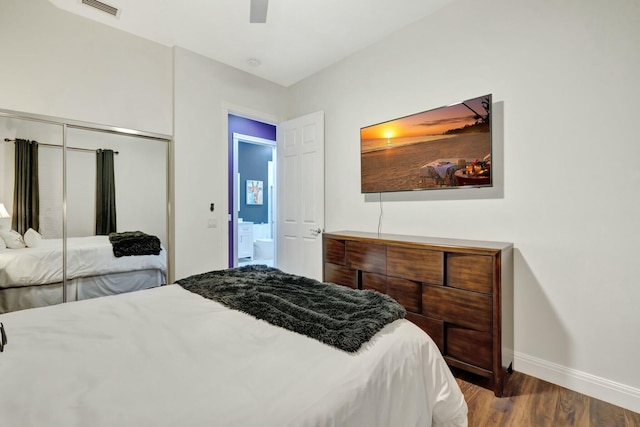 bedroom with visible vents, baseboards, ceiling fan, wood finished floors, and a closet