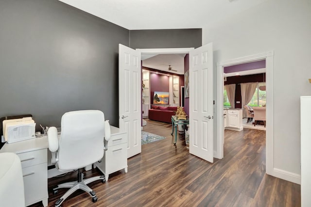 home office featuring dark wood-style flooring and baseboards