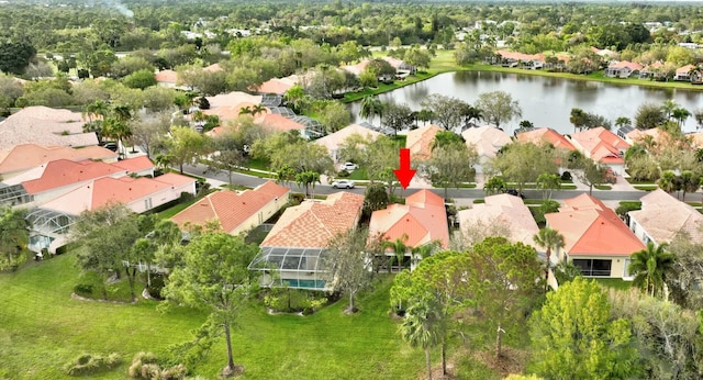 drone / aerial view featuring a water view and a residential view