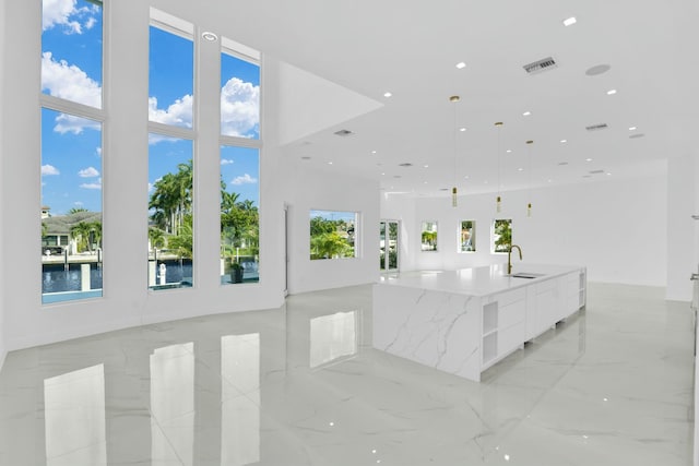 interior space with marble finish floor, a sink, visible vents, and recessed lighting