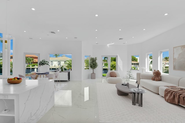 living room featuring marble finish floor, visible vents, and recessed lighting