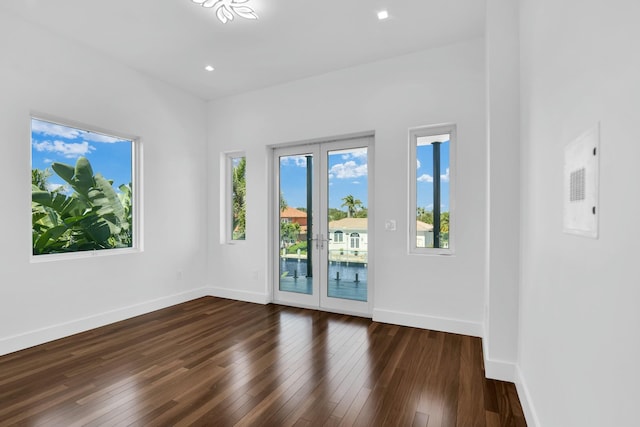 interior space with baseboards, dark wood-type flooring, and recessed lighting