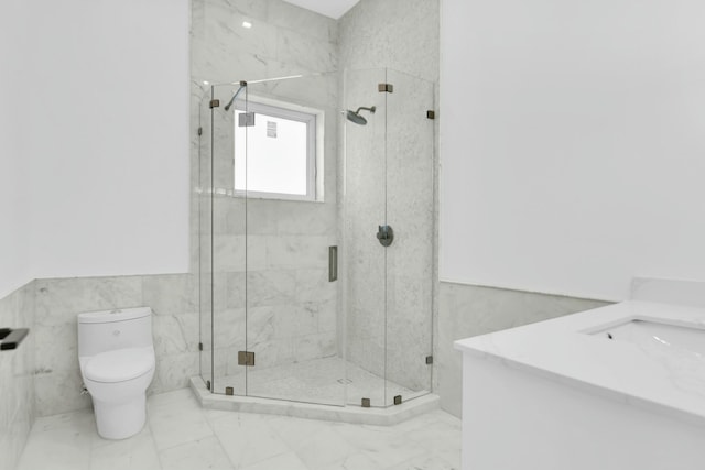 full bathroom featuring marble finish floor, a marble finish shower, toilet, and tile walls