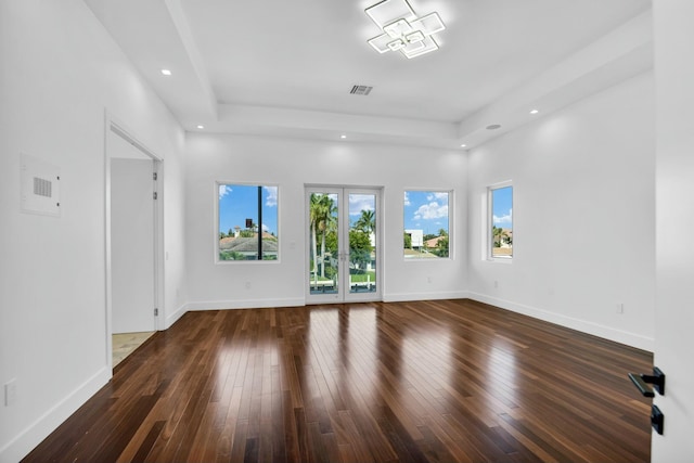 interior space featuring dark wood-style floors, visible vents, and baseboards