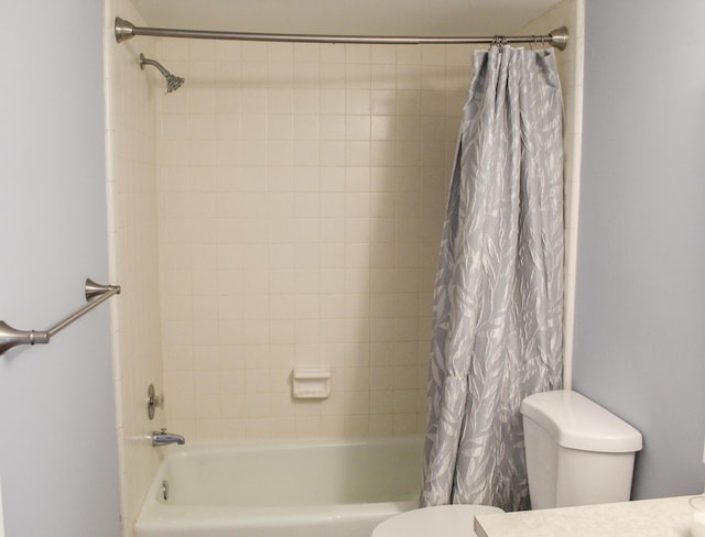 bathroom featuring shower / tub combo and toilet