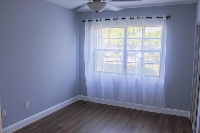 empty room featuring ceiling fan, baseboards, and dark wood-style flooring