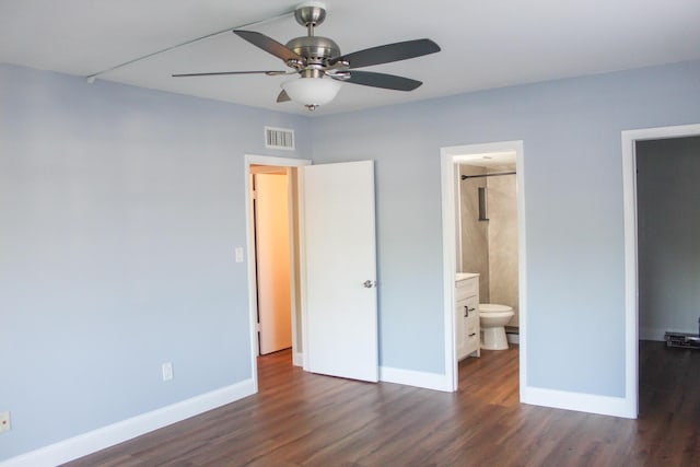 unfurnished bedroom featuring ceiling fan, connected bathroom, dark wood-type flooring, visible vents, and baseboards