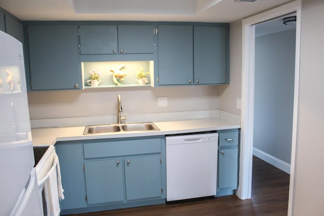 kitchen with white appliances, light countertops, a sink, and dark wood-style flooring