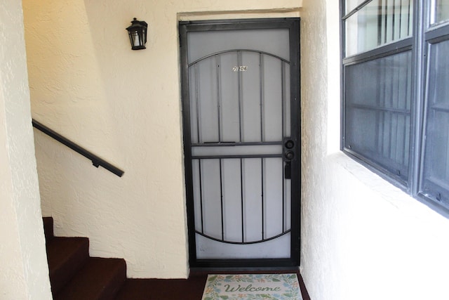 entrance to property with stucco siding