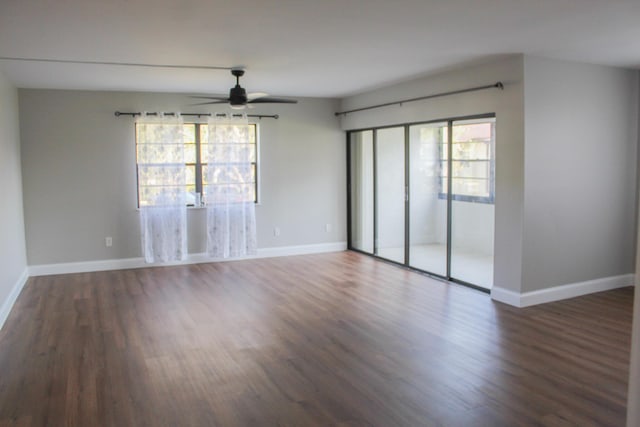 unfurnished room featuring ceiling fan, baseboards, and wood finished floors