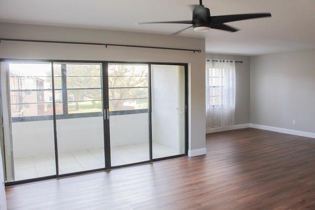 unfurnished bedroom with a ceiling fan, baseboards, and wood finished floors