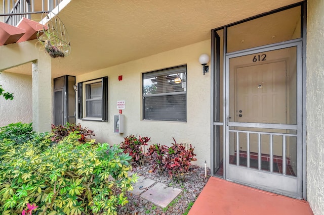 entrance to property with stucco siding