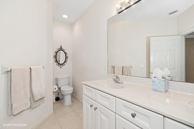 full bathroom featuring double vanity, visible vents, toilet, a sink, and tile patterned flooring