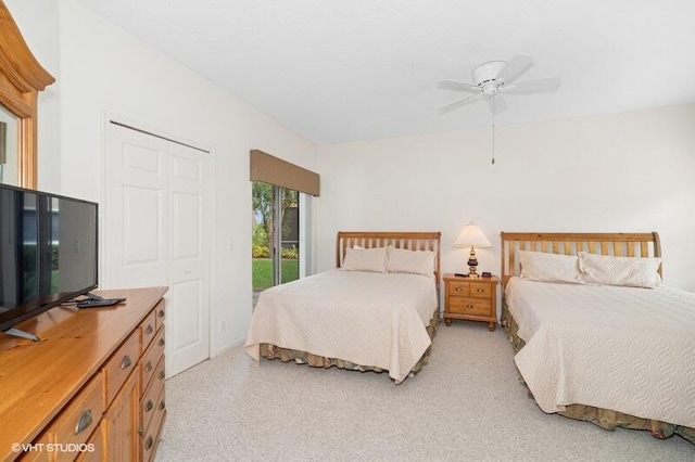 bedroom with access to outside, a ceiling fan, and a closet