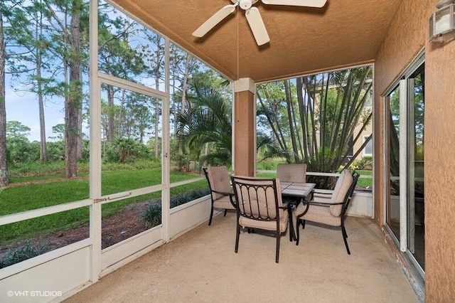 sunroom featuring a ceiling fan