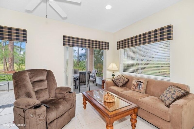 living area featuring light tile patterned floors, plenty of natural light, and a ceiling fan