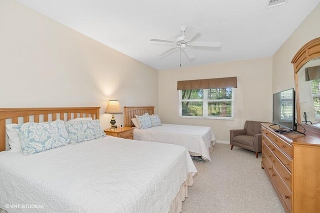 bedroom featuring light carpet and ceiling fan