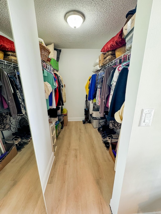 spacious closet featuring wood finished floors