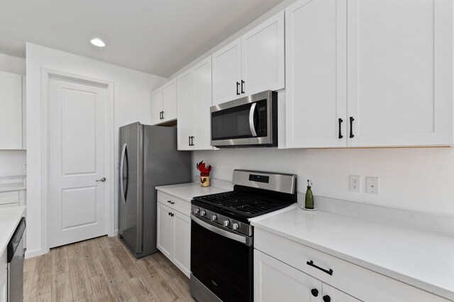 kitchen with light countertops, appliances with stainless steel finishes, and white cabinetry