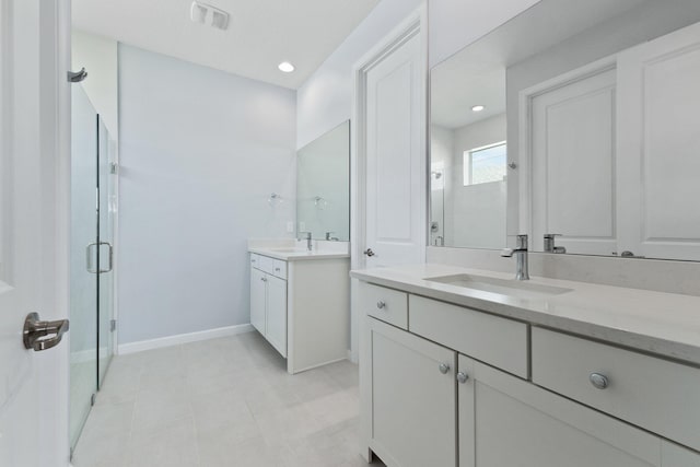 full bathroom featuring two vanities, a sink, baseboards, visible vents, and a shower stall