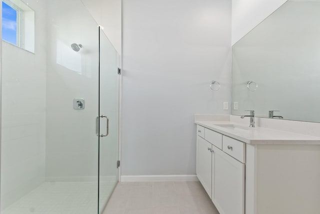 full bathroom featuring a shower stall, vanity, and baseboards