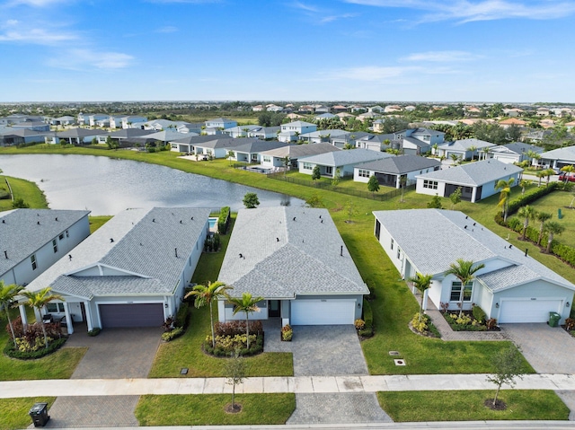 bird's eye view featuring a water view and a residential view