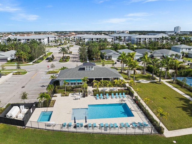 pool featuring a residential view, a patio area, and fence