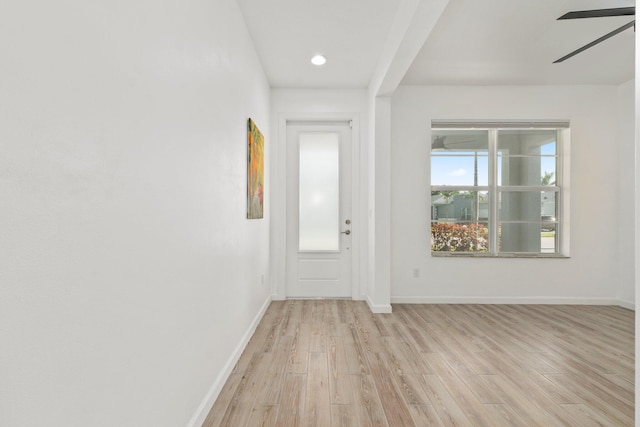 entryway featuring light wood finished floors, baseboards, and a ceiling fan