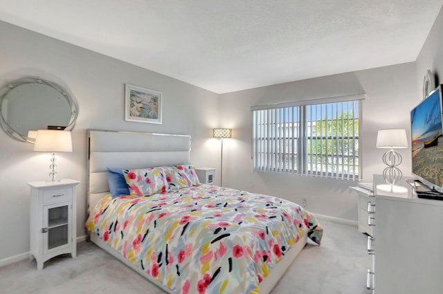 bedroom featuring baseboards and light colored carpet