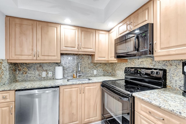 kitchen with black appliances and light brown cabinetry