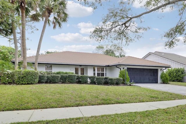 ranch-style house with an attached garage, a front yard, concrete driveway, and a tiled roof