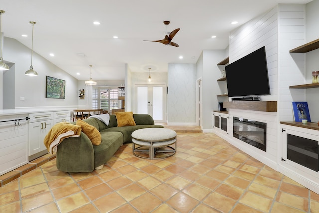 living area featuring vaulted ceiling, ceiling fan, a fireplace, and recessed lighting