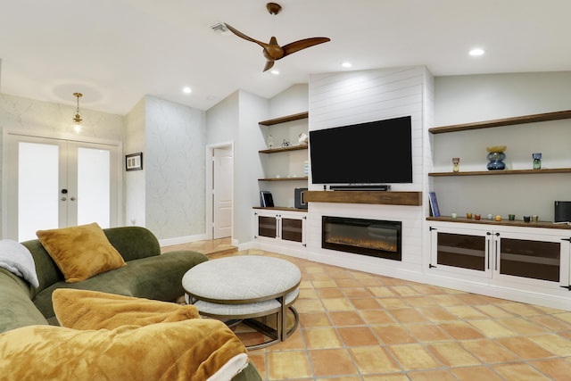 living area with baseboards, vaulted ceiling, french doors, a fireplace, and recessed lighting