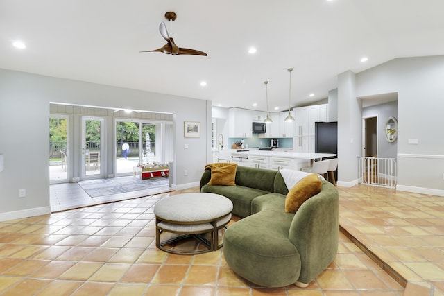 living area featuring vaulted ceiling, light tile patterned floors, baseboards, and recessed lighting