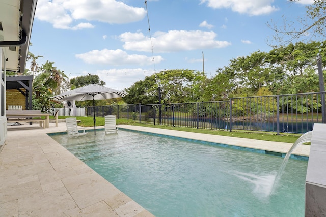 view of swimming pool featuring a patio area, fence, and a fenced in pool